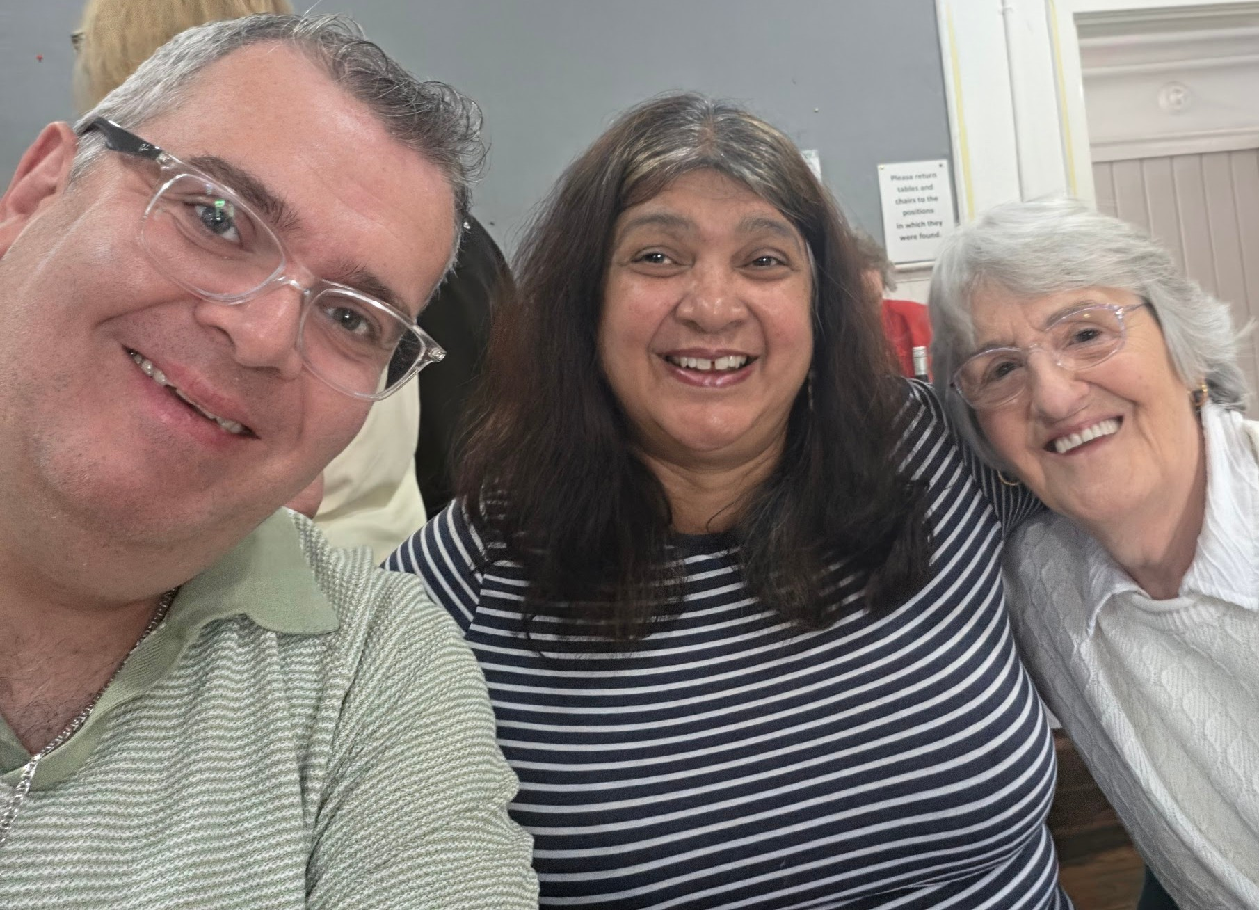 Three people smiling at the camera.